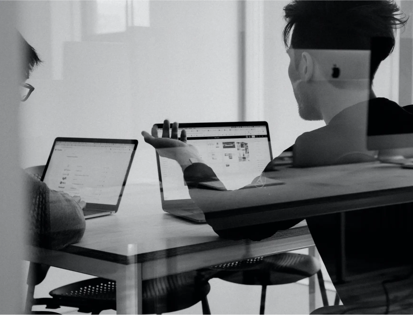 Black and White photo of two people in a meeting room